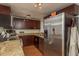 Well-appointed kitchen with stainless refrigerator, granite counters and rich, dark cabinetry at 11320 125Th Ter, Largo, FL 33778