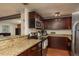 Spacious kitchen features stainless appliances, granite counters and rich, dark cabinetry at 11320 125Th Ter, Largo, FL 33778