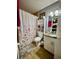 Compact bathroom featuring a shower with curtain, toilet, and vanity with storage at 11521 Paperwood Pl, Riverview, FL 33579