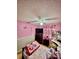 bedroom with pink walls, neutral carpet, and coordinating Princess themed decor at 11521 Paperwood Pl, Riverview, FL 33579