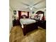 Well-lit bedroom features a dark wood bedroom set, neutral paint, and tile flooring at 11521 Paperwood Pl, Riverview, FL 33579