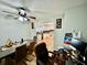 A dining room featuring an office work area with a view into the modern kitchen with white cabinets at 11521 Paperwood Pl, Riverview, FL 33579