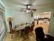 Open dining area featuring a modern ceiling fan, a table for six, and access to the kitchen at 11521 Paperwood Pl, Riverview, FL 33579