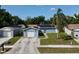 A quaint blue house showcases solar panels, a one-car garage, and a tidy front yard, offering suburban charm at 11521 Paperwood Pl, Riverview, FL 33579