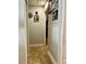 Hallway featuring neutral paint, tile flooring, and a view leading to a bedroom at 11521 Paperwood Pl, Riverview, FL 33579