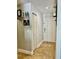 Bright hallway with neutral paint, tile flooring, with decor accents including art and shelves at 11521 Paperwood Pl, Riverview, FL 33579