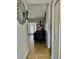 Inviting hallway features neutral paint, tile flooring, and a peek into the living room with access to a patio at 11521 Paperwood Pl, Riverview, FL 33579