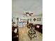 Inviting living room with a ceiling fan, tile flooring and glass table near a bar area at 11521 Paperwood Pl, Riverview, FL 33579