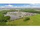 Aerial view of a lakeside community surrounded by lush greenery at 12026 Crestridge Loop, New Port Richey, FL 34655