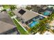 An aerial view shows a home with a screened pool and backyard shed at 12026 Crestridge Loop, New Port Richey, FL 34655