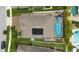 Birds eye view of backyard pool, solar panels and green grass surrounding a single Gathering home at 12026 Crestridge Loop, New Port Richey, FL 34655