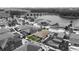 Aerial view of a home with a screened pool and palm trees at 12026 Crestridge Loop, New Port Richey, FL 34655