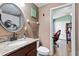 Updated bathroom features modern fixtures, including granite countertop and vanity at 12026 Crestridge Loop, New Port Richey, FL 34655