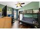 Bedroom features a bunk bed, desk, and modern decor with dark-colored vinyl flooring at 12026 Crestridge Loop, New Port Richey, FL 34655