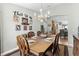 A dining room with Gathering photos and a doorway view to the kitchen at 12026 Crestridge Loop, New Port Richey, FL 34655