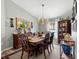 Traditional dining room features a wood table, chandelier, and decorative wall art at 12026 Crestridge Loop, New Port Richey, FL 34655