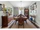 Traditional dining room with hardwood floors, area rug, chandelier, and decorative mirror at 12026 Crestridge Loop, New Port Richey, FL 34655