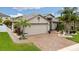 Beautiful home with a brick driveway, lush landscaping, and a spacious two-car garage in a quiet neighborhood at 12026 Crestridge Loop, New Port Richey, FL 34655