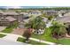 Well-manicured front yard of a home with palm trees and lush landscaping at 12026 Crestridge Loop, New Port Richey, FL 34655