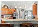 Kitchen featuring a breakfast bar, wooden cabinets, and decorative lighting at 12026 Crestridge Loop, New Port Richey, FL 34655