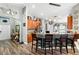 Open kitchen featuring breakfast bar, wood cabinets, decorative lighting, and tile floors at 12026 Crestridge Loop, New Port Richey, FL 34655