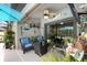 Covered lanai with outdoor seating, ceiling fan, and decorative beach decor offers a relaxing space at 12026 Crestridge Loop, New Port Richey, FL 34655