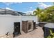 Outdoor kitchen with smoker and brick oven situated in a paved outdoor area perfect for Gathering gatherings at 12026 Crestridge Loop, New Port Richey, FL 34655