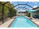 Beautiful screened pool and patio area with sunny skies and tropical landscaping offers private backyard retreat at 12026 Crestridge Loop, New Port Richey, FL 34655