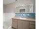 Bathroom with a large mirror, vanity, and blue tiled wall at 1217 W Terrace Dr, Plant City, FL 33563