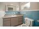 The bathroom features blue tile accents, a vanity with storage, and a functional toilet at 1217 W Terrace Dr, Plant City, FL 33563