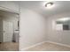 Bedroom featuring neutral walls, tile flooring and access to the laundry room at 1217 W Terrace Dr, Plant City, FL 33563