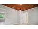 Cozy bedroom with a wood ceiling, neutral walls, and tile flooring at 1217 W Terrace Dr, Plant City, FL 33563