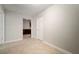 Bedroom with neutral paint, tile floor, white trim, and access to the kitchen at 1217 W Terrace Dr, Plant City, FL 33563
