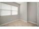Bright bedroom featuring tile floors and a window with blinds, offering a simple and clean space at 1217 W Terrace Dr, Plant City, FL 33563
