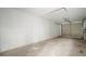 Spacious garage with concrete floor and a functional roll-up door at 1217 W Terrace Dr, Plant City, FL 33563