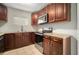 Updated kitchen features stainless steel appliances, granite countertops, and dark wood cabinets at 1217 W Terrace Dr, Plant City, FL 33563