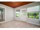 Sunroom with a striking wood ceiling, large windows offering ample natural light, and durable tile flooring at 1217 W Terrace Dr, Plant City, FL 33563