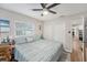Bedroom with a ceiling fan, large window, ensuite bathroom and two closets at 1312 S Evergreen Ave, Clearwater, FL 33756