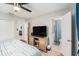 Bedroom featuring TV, two closets, ensuite bathroom and wood-look floors at 1312 S Evergreen Ave, Clearwater, FL 33756