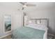 Bright bedroom with a barn-style headboard, ensuite bathroom, and ceiling fan at 1312 S Evergreen Ave, Clearwater, FL 33756