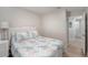 Small bedroom with a white wicker bed frame, beach-themed bedding and access to bathroom at 1312 S Evergreen Ave, Clearwater, FL 33756