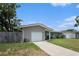 View of front of home with driveway and garage door at 1312 S Evergreen Ave, Clearwater, FL 33756
