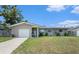 Charming single-story home with a well-manicured lawn and a cozy front porch at 1312 S Evergreen Ave, Clearwater, FL 33756