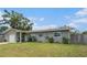 Charming single-story home with a well-manicured lawn and front door at 1312 S Evergreen Ave, Clearwater, FL 33756