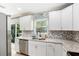 Modern kitchen with white cabinets and stainless steel appliances at 1312 S Evergreen Ave, Clearwater, FL 33756