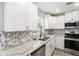 Modern kitchen with stainless steel appliances, granite countertops, and stylish backsplash at 1312 S Evergreen Ave, Clearwater, FL 33756