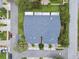Birds-eye view of the home showing a roof, driveway, and surrounding manicured lawns and mature trees at 13636 Lake Point S Dr, Clearwater, FL 33762