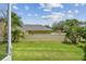 Lush backyard with green grass and privacy wall, perfect for outdoor enjoyment and relaxation at 13636 Lake Point S Dr, Clearwater, FL 33762