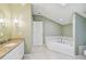 Bathroom featuring a jetted tub, granite vanity and earth tone color palette at 13636 Lake Point S Dr, Clearwater, FL 33762