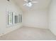 Bright bedroom features carpeted floors, ceiling fan, and white shuttered windows at 13636 Lake Point S Dr, Clearwater, FL 33762